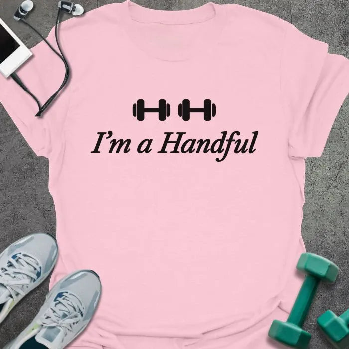 Light pink t-shirt printed with "I'm a Handful" in black, with two dumbbell icons