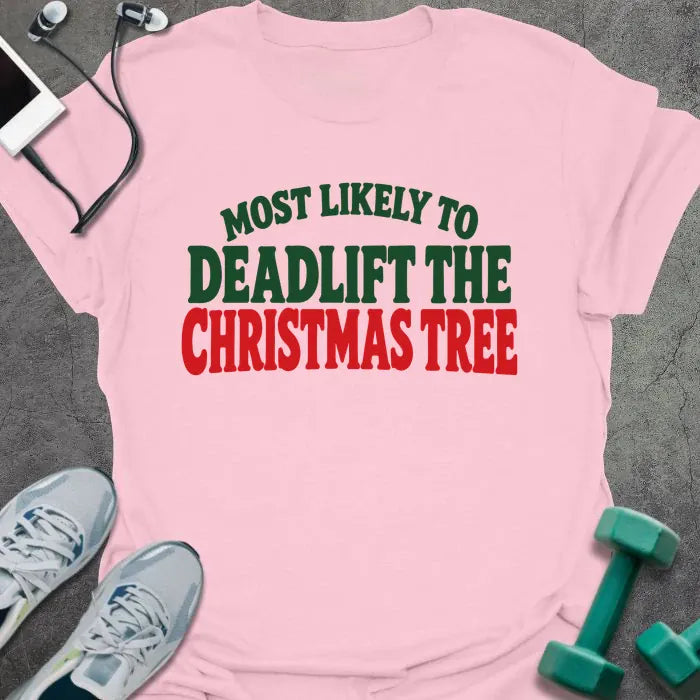 Light pink t-shirt printed with "MOST LIKELY TO DEADLIFT THE CHRISTMAS TREE" in green and red