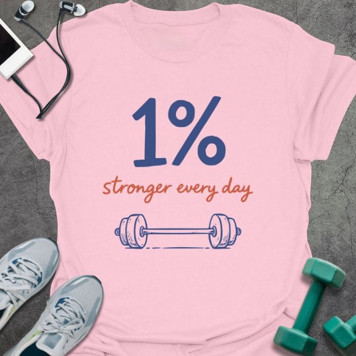 Light pink t-shirt printed with "1% stronger every day" in blue and red, with dumbbell illustration