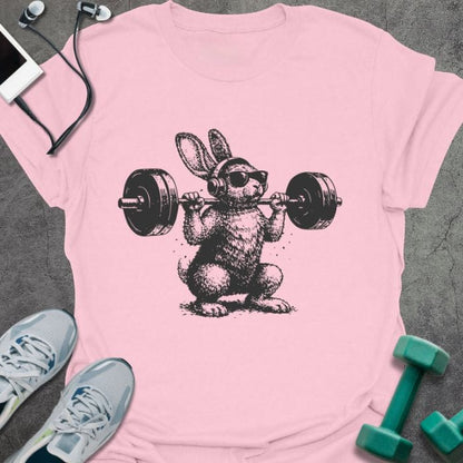 Light pink t-shirt with an illustration of a bunny doing a squat with dumbbells in black