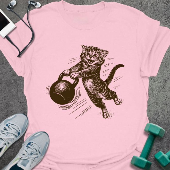 Light pink t-shirt with a cat swinging a kettlebell in brown, tan