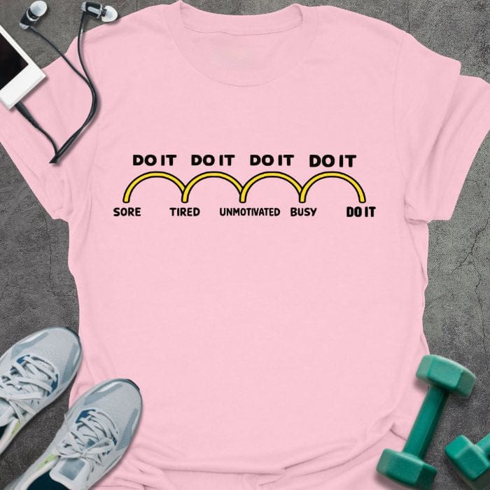 Light pink t-shirt printed with "Do it Do it Do it Do it Sore Tired Unmotivated Busy Do it" in yellow, with banana shapes as progress bars