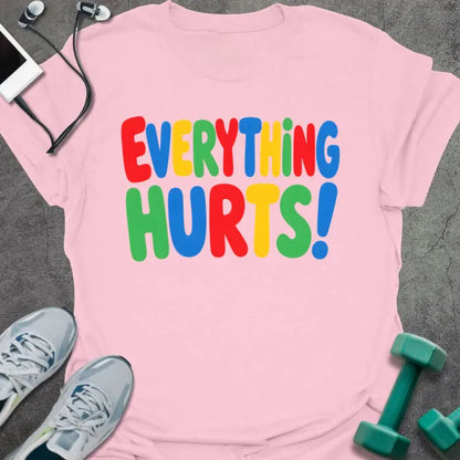 Light pink t-shirt printed with "EVERYTHING HURTS!" in rainbow