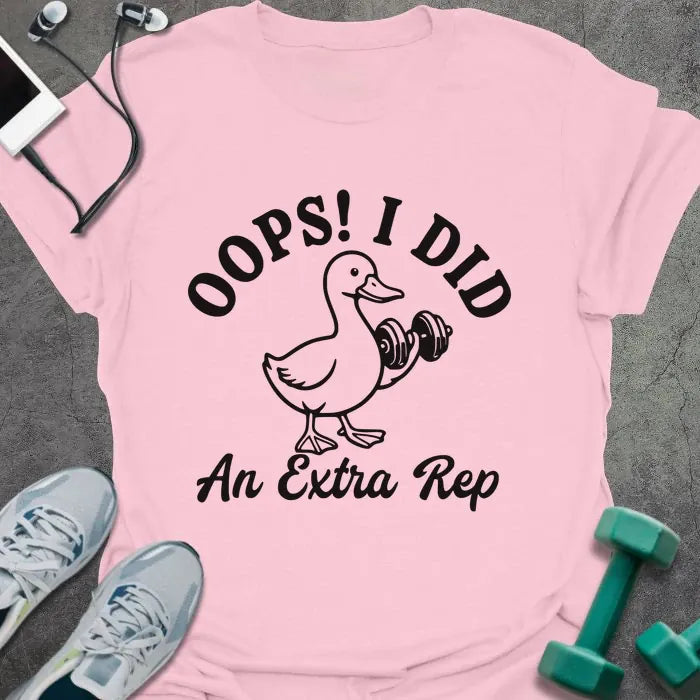 Light pink t-shirt printed with "OOPS! I DID An Extra Rep" in black, with a duck holding a dumbbell