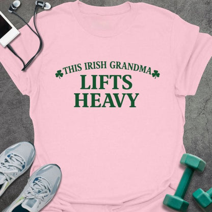 Light pink t-shirt printed with "This Irish Grandma Lifts Heavy" in green, with clover