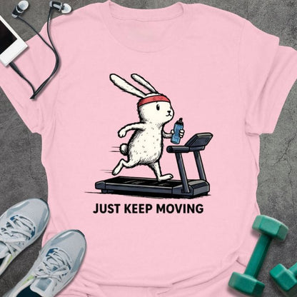 Light pink t-shirt printed with "Just Keep Moving", with a rabbit on a treadmill