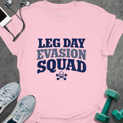Light pink t-shirt printed with "Leg Day Evasion Squad" in navy blue, light gray, with a skull and crossbones
