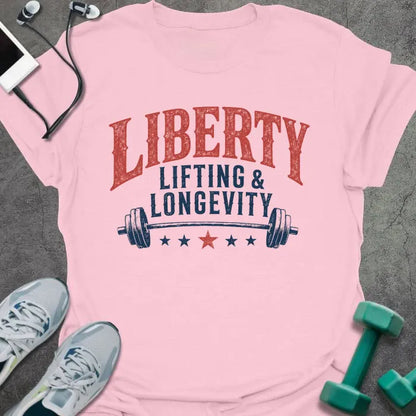 Light pink t-shirt printed with "Liberty Lifting & Longevity" in blue and red, with a barbell and stars