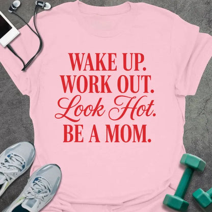 Light pink t-shirt printed with "WAKE UP. WORK OUT. Look Hot. BE A MOM." in red