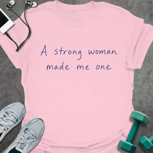 Light Pink t-shirt printed with "A strong woman made me one" in blue handwritten lettering