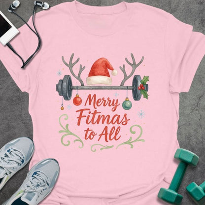 Light pink t-shirt printed with "Merry Fitmas to All" in red and green, with a barbell and holiday decorations