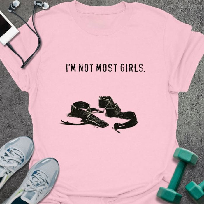 Light pink t-shirt printed with "I'm Not Most Girls.", with lifting straps