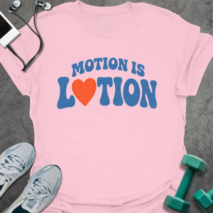 Light Pink t-shirt printed with "MOTION IS LOTION" in blue and orange, with heart icon