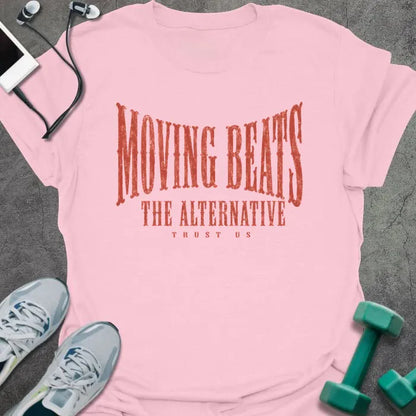 Light Pink t-shirt printed with "MOVING BEATS THE ALTERNATIVE TRUST US" in coral