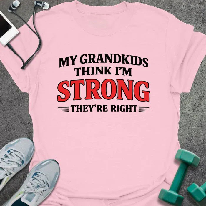 Light pink t-shirt printed with "My Grandkids Think I'm Strong They're Right" in black and red