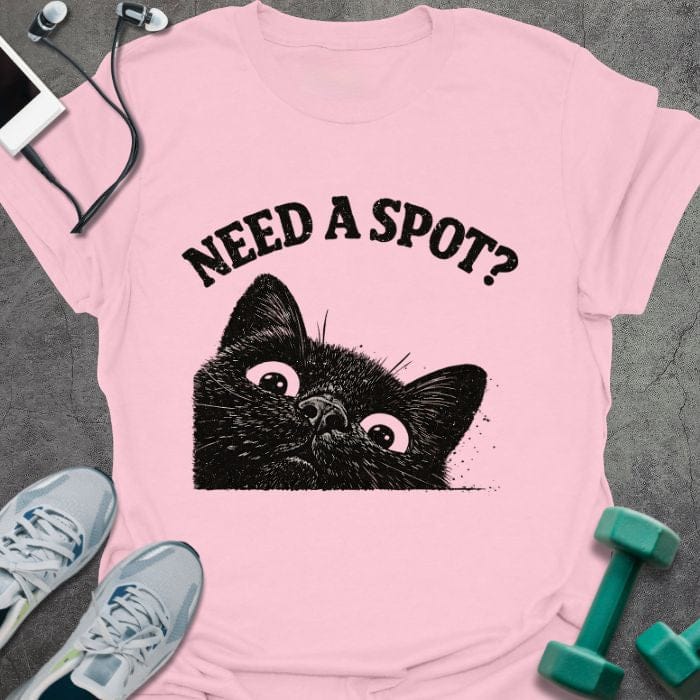 Light pink t-shirt printed with "Need a Spot?" in black, with an illustration of a cat's face looking up