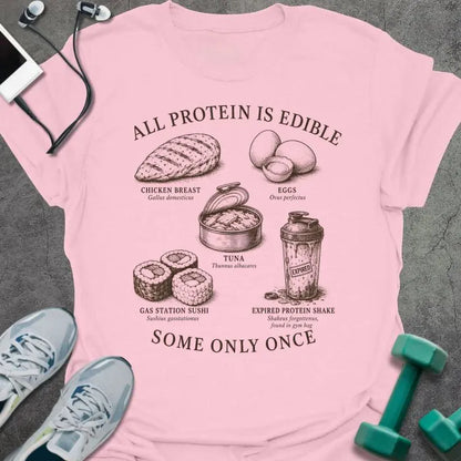 Light Pink t-shirt printed with "ALL PROTEIN IS EDIBLE" in black text with sepia-tone engraving style illustrations and 'SOME ONLY ONCE' at bottom