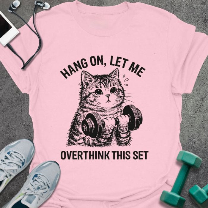 Light pink t-shirt printed with "Hang on, Let Me Overthink This Set", with a cat holding dumbbells