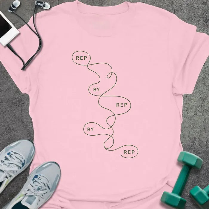Light pink t-shirt printed with "REP BY REP BY REP" in green line art, with squiggle graphic