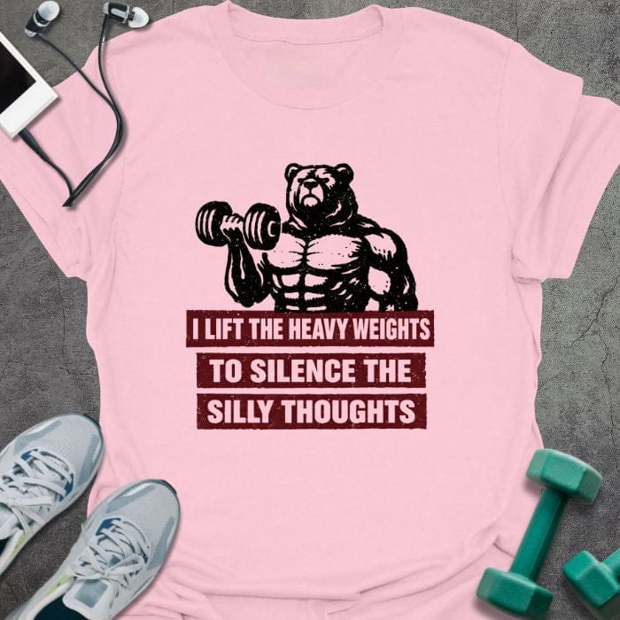 Light pink t-shirt printed with "I Lift the Heavy Weights to Silence the Silly Thoughts" in red and black, with muscular bear lifting dumbbell