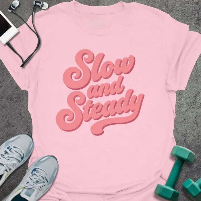 Light pink t-shirt printed with "Slow and Steady" in rose and pink