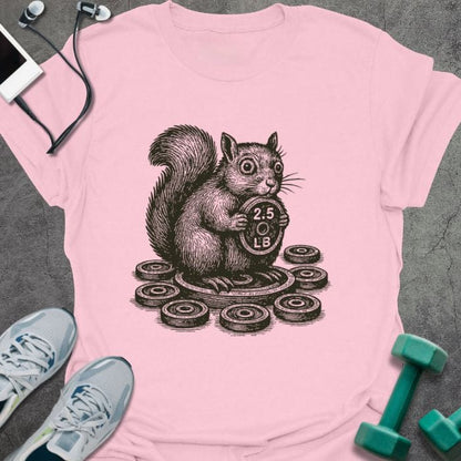 Light pink t-shirt with squirrel holding dumbbells surrounded by weights
