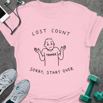 Light pink t-shirt printed with "Lost Count Sorry, Start Over", with stick figure with raised arms