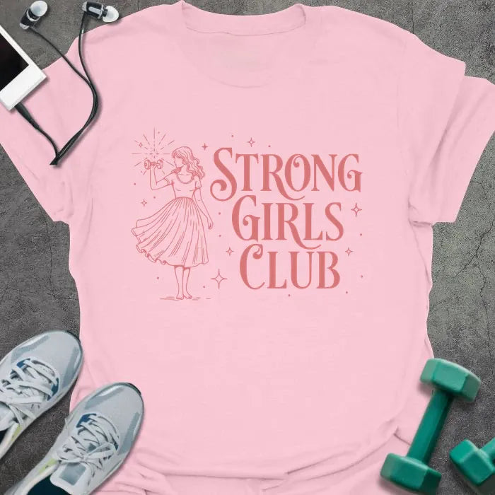 Light pink t-shirt printed with "Strong Girls Club" in pink, with a girl illustration and sparkles