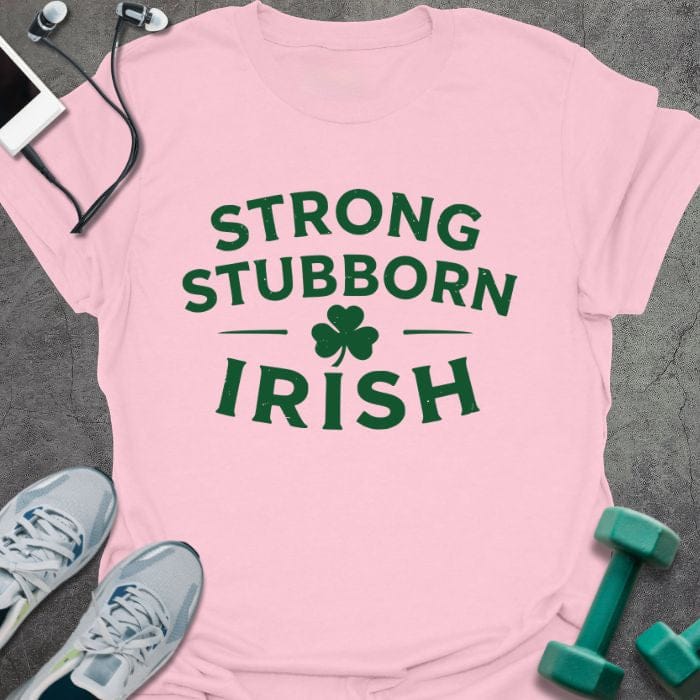 Light pink t-shirt printed with "Strong Stubborn Irish" in green, with clover