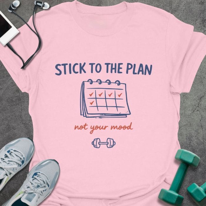 Light pink t-shirt printed with "STICK TO THE PLAN not your mood" in red and blue, with calendar and checkmarks illustration