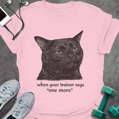 Light pink t-shirt printed with "when your trainer says "one more", with a realistic unamused black cat portrait
