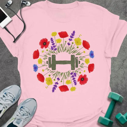 Light pink t-shirt with an illustration of multicolor wildflowers surrounding a dumbbell in multicolor