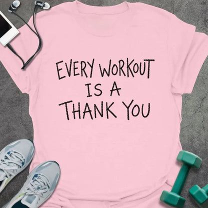 Light Pink t-shirt printed with "EVERY WORKOUT IS A THANK YOU" in black handwritten-style text