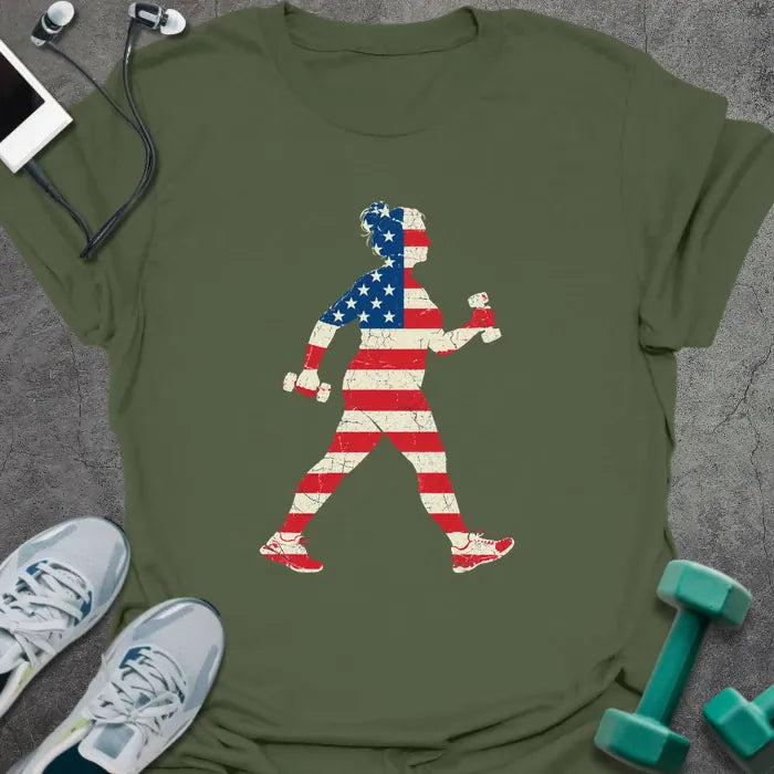 Military green t-shirt printed with a woman power walking with hand weights, filled with a distressed American flag