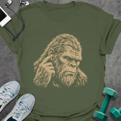 Military green t-shirt with an illustration of Bigfoot's face with a concerned expression in white