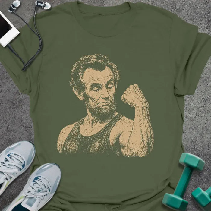Military green t-shirt with a portrait of Abraham Lincoln holding a medicine ball in white