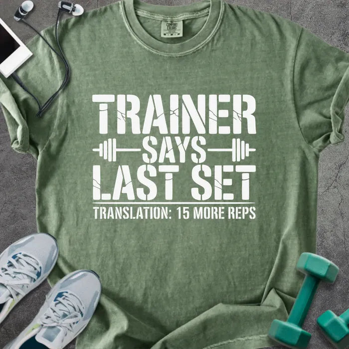 Moss t-shirt printed with "Trainer Says Last Set Translation: 15 More Reps" in white, with a barbell graphic