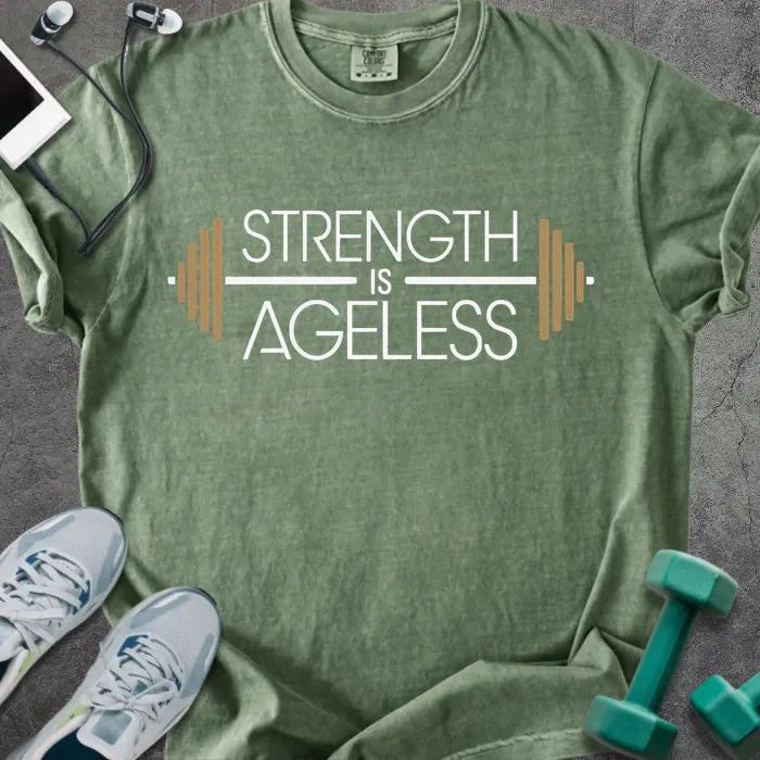 Moss t-shirt printed with "Strength is Ageless" in white and gold, with a barbell graphic