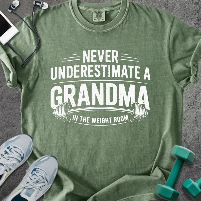 Moss t-shirt printed with "Never Underestimate a Grandma in the Weight Room" in white, with a barbell graphic