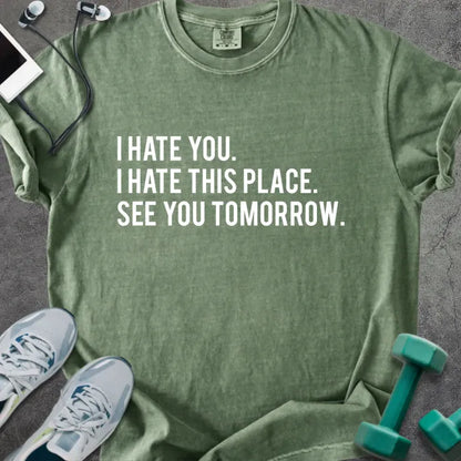 Moss t-shirt printed with "I Hate You. I Hate This Place. See You Tomorrow." in white