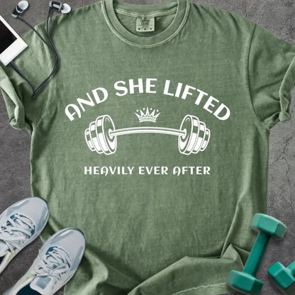 Moss t-shirt printed with "And She Lifted Heavily Ever After" in white, with a barbell and crown