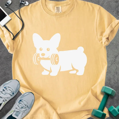 Mustard t-shirt with a corgi holding dumbbells graphic in white