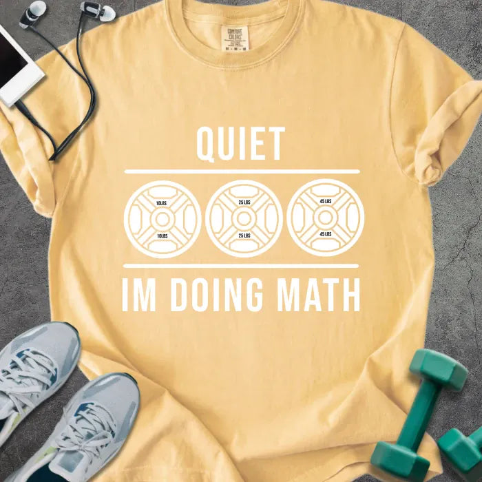Mustard t-shirt printed with "Quiet Im Doing Math" in white, with three weight plate graphics