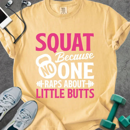 Mustard t-shirt printed with "SQUAT Because NOBODY RAPS ABOUT LITTLE BUTTS" in pink and white