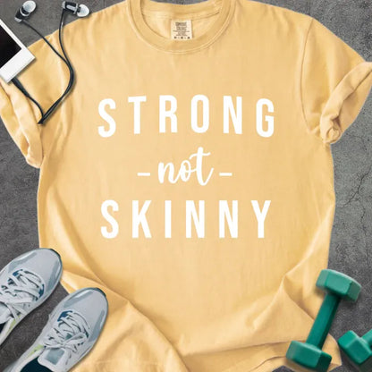 Mustard t-shirt printed with "STRONG -not- SKINNY" in white