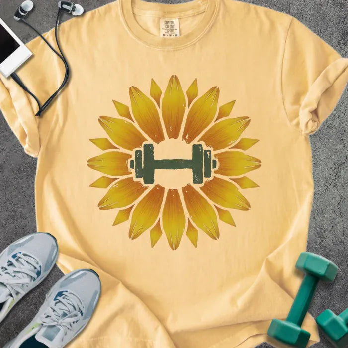 Mustard t-shirt with yellow sunflower and dumbbell in center in yellow and green