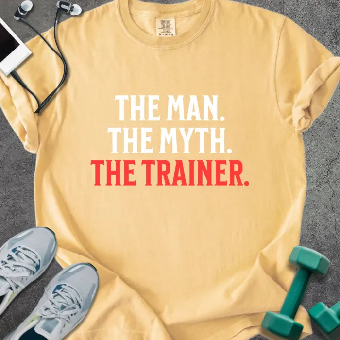 Mustard t-shirt printed with "The Man. the Myth. the Trainer." in red