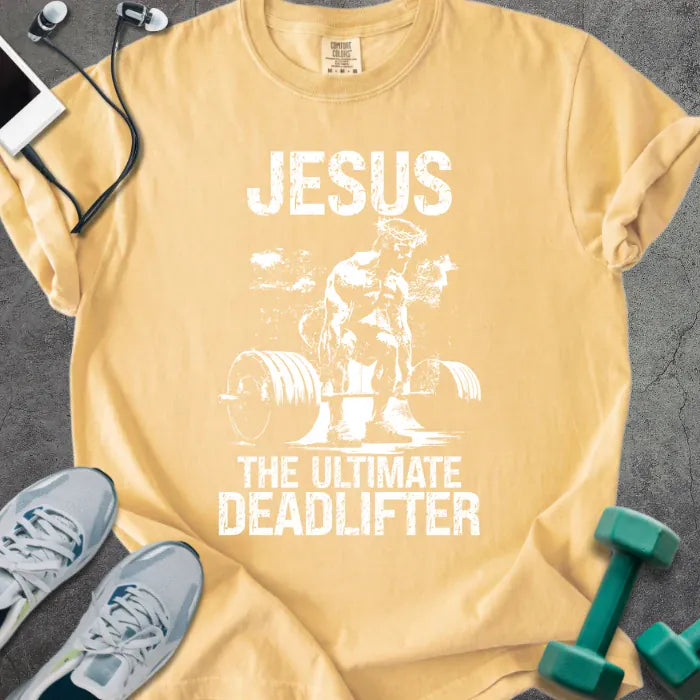Mustard t-shirt printed with "Jesus the Ultimate Deadlifter" in white, with Jesus doing a deadlift