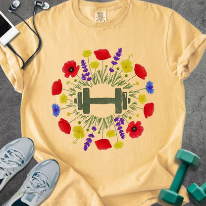 Mustard t-shirt with colorful wildflowers and dumbbells in circular arrangement in red, yellow, purple, blue, and green