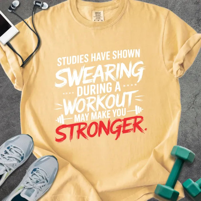 Mustard t-shirt printed with "Studies Have Shown Swearing During a Workout May Make You Stronger" in red